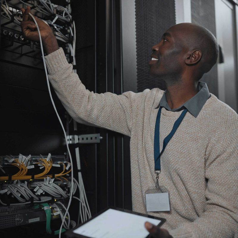 engineer-server-room-and-black-man-with-cable-and-2023-03-01-21-35-11-utc-min